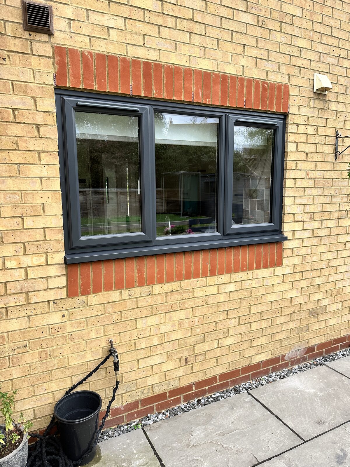 Anthracite window on yellow brick
