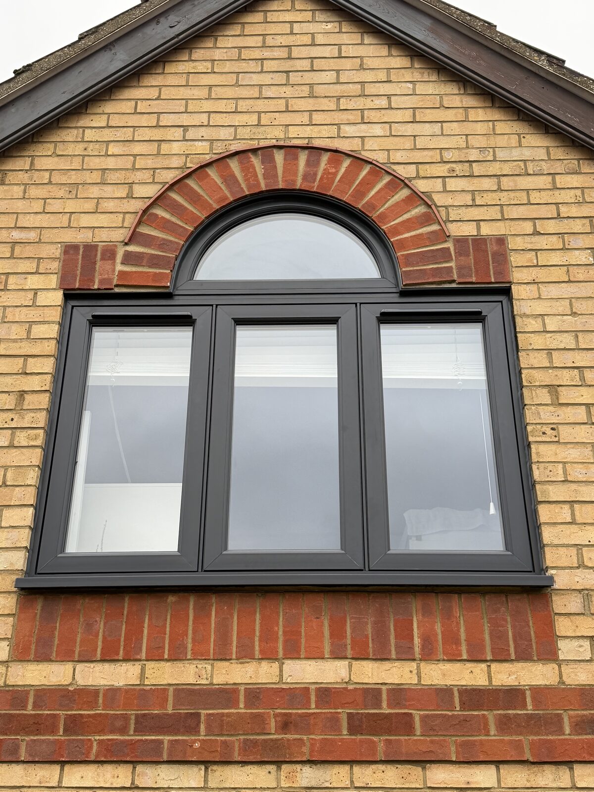 Anthracite windows with arched brick head